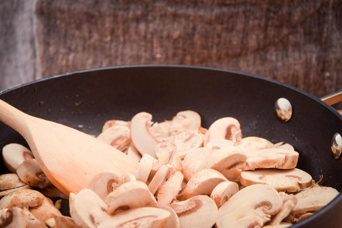 Sliced mushrooms in pan.