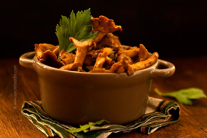 Sauteed chanterelles with garlic in small serving pot.