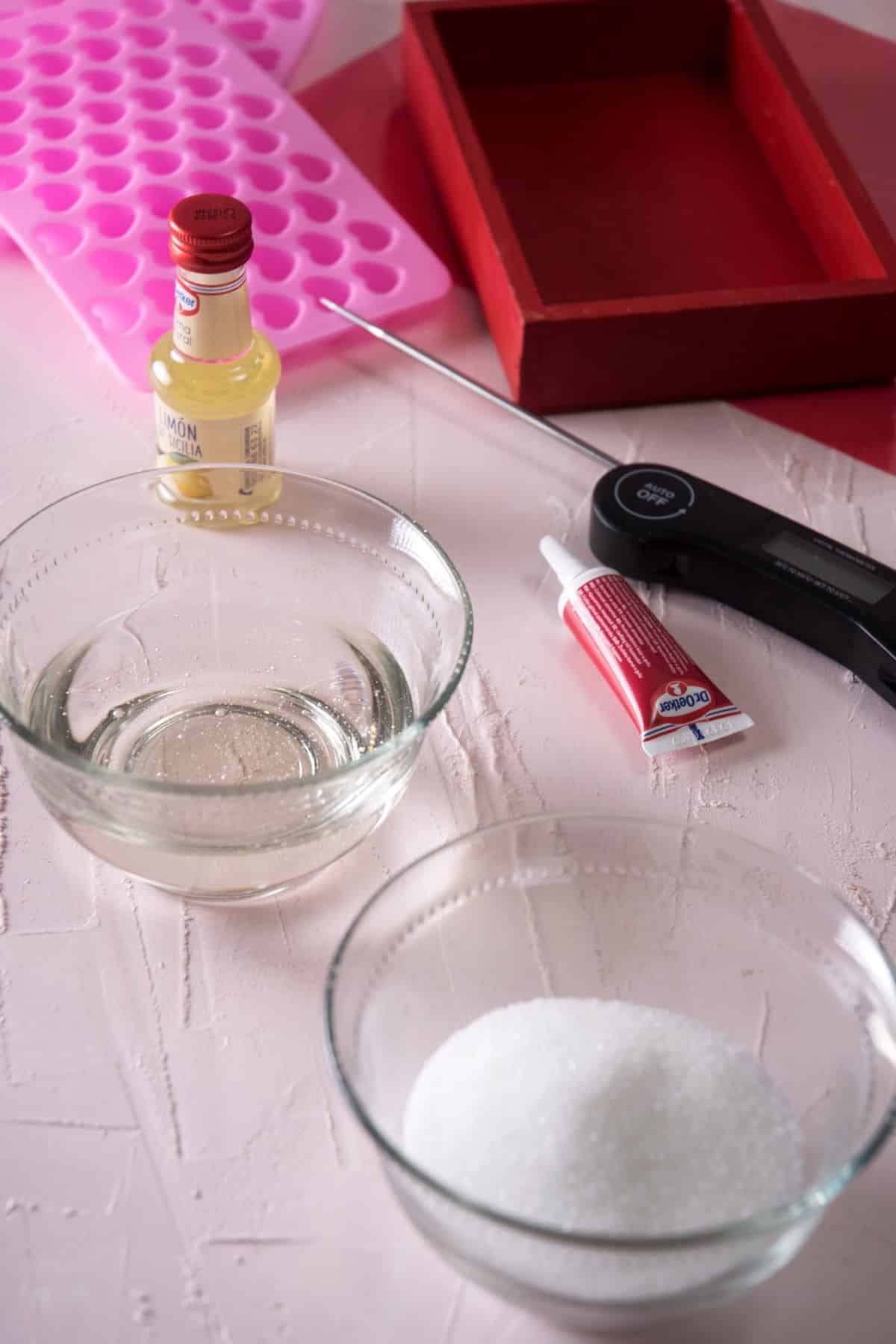 Strawberry candy ingredients prepped on light background.
