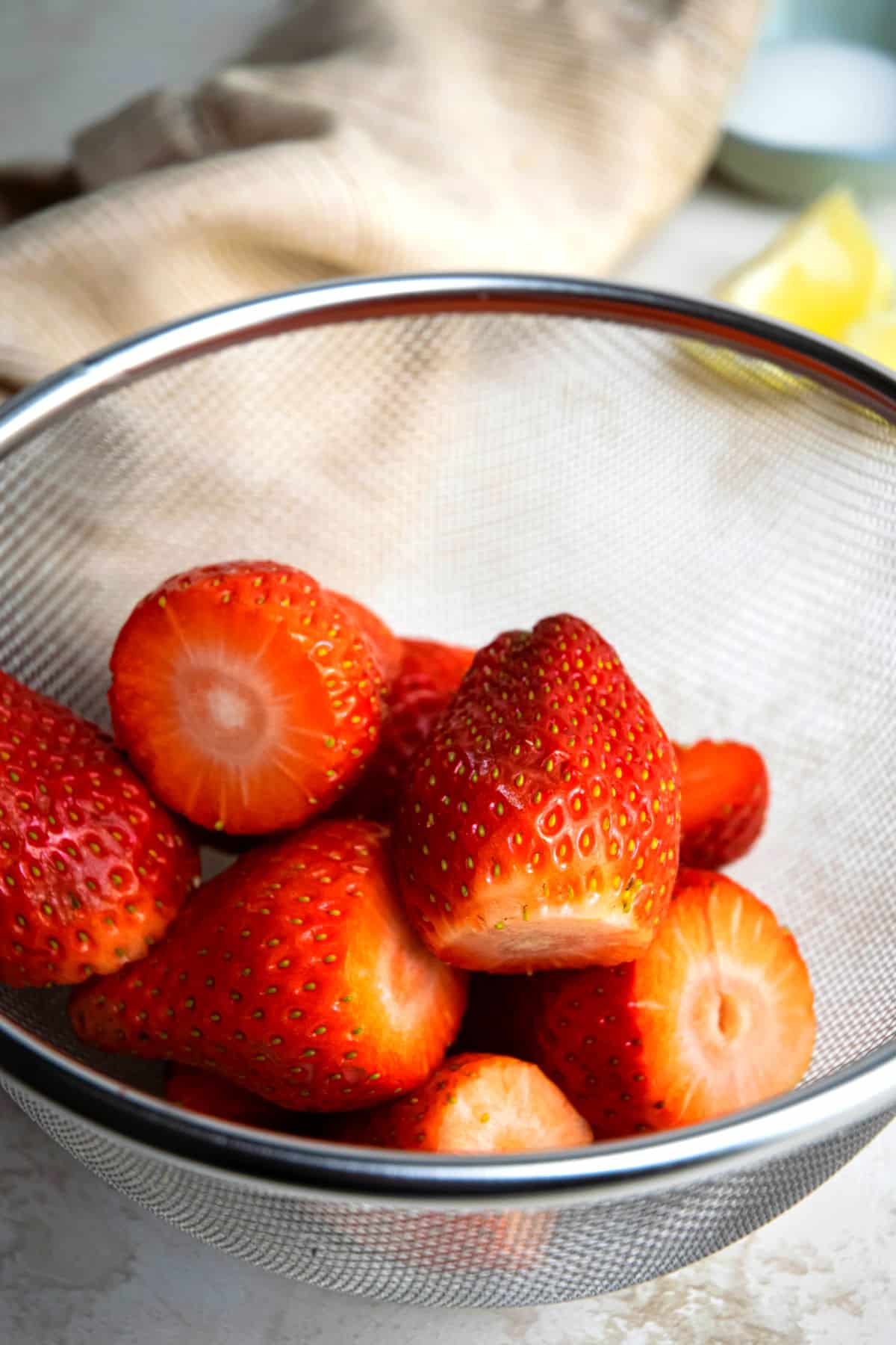 Strawberries in mesh strainer.