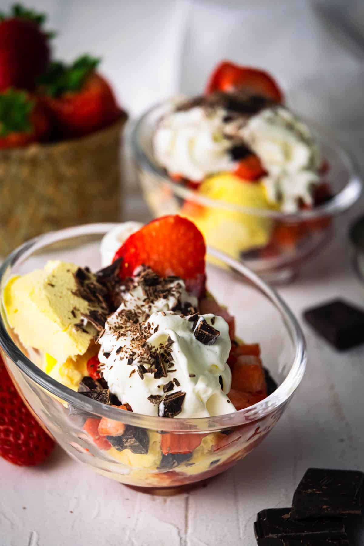 Strawberry ice cream sundae in dessert bowls.