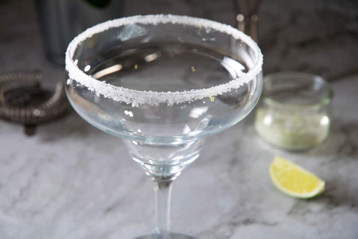 Lime sugar rim on margarita glass on marble background.