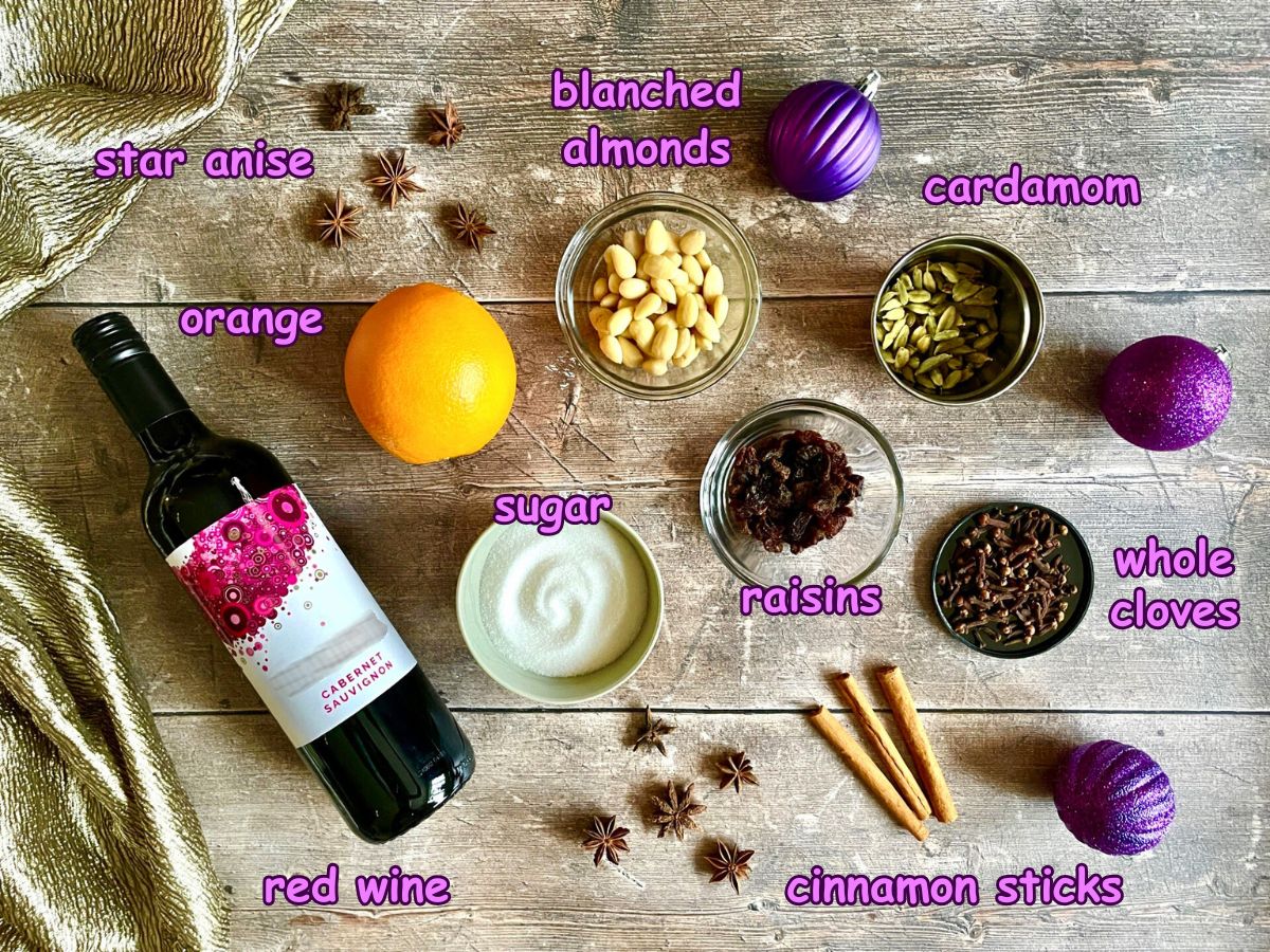 Swedish glögg ingredients labeled on wooden background.