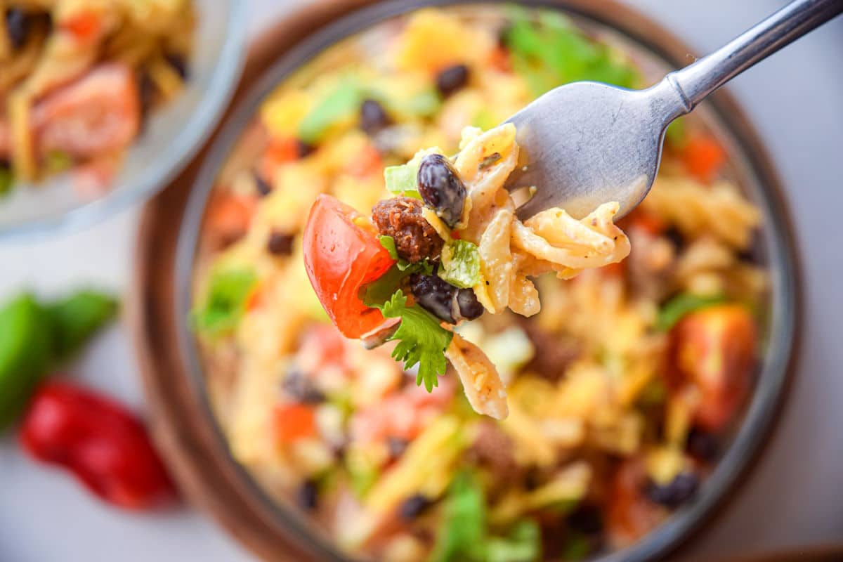 Taco pasta salad on a fork.