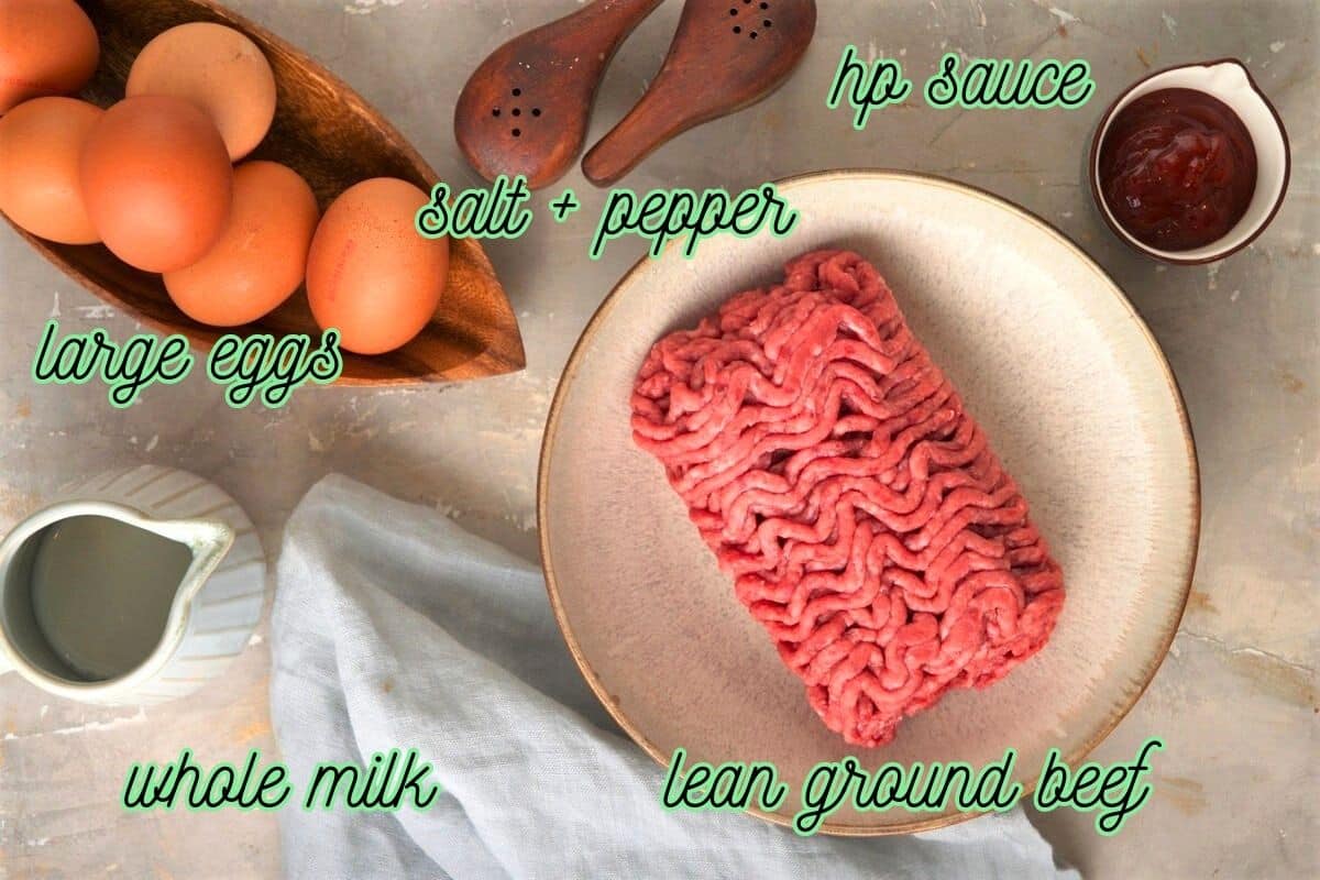 Hamburger scrambled eggs ingredients prepped on marble background.