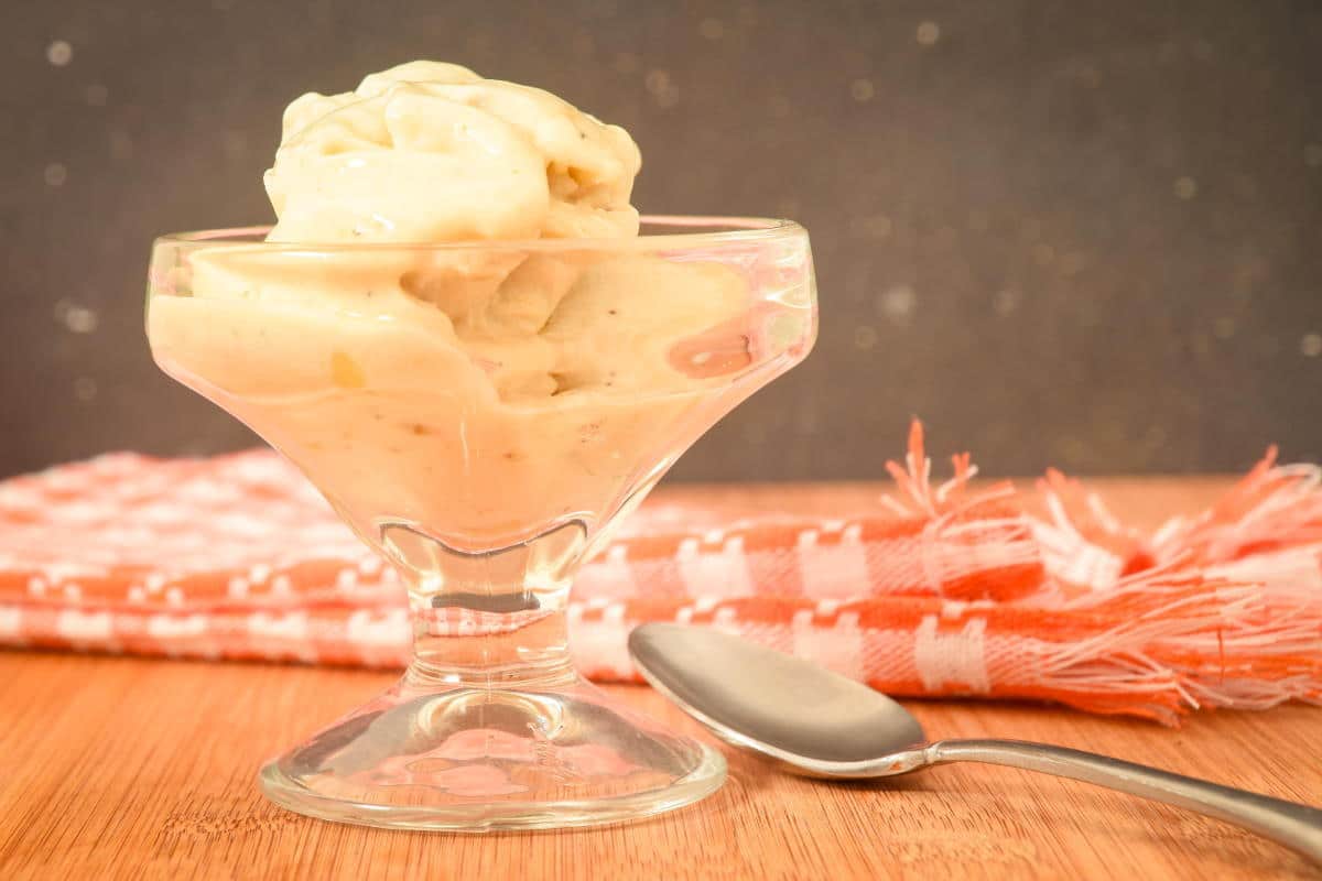 How to Make Banana Ice Cream Final 1 Vegan banana ice cream in a dessert dish with a spoon on the side.