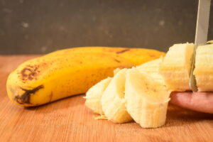 Slicing bananas on a cutting board.