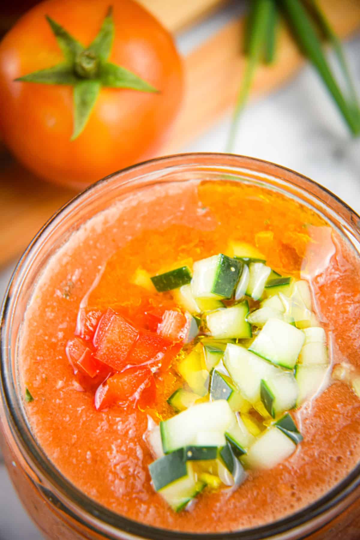 Watermelon gazpacho in a glass jar.