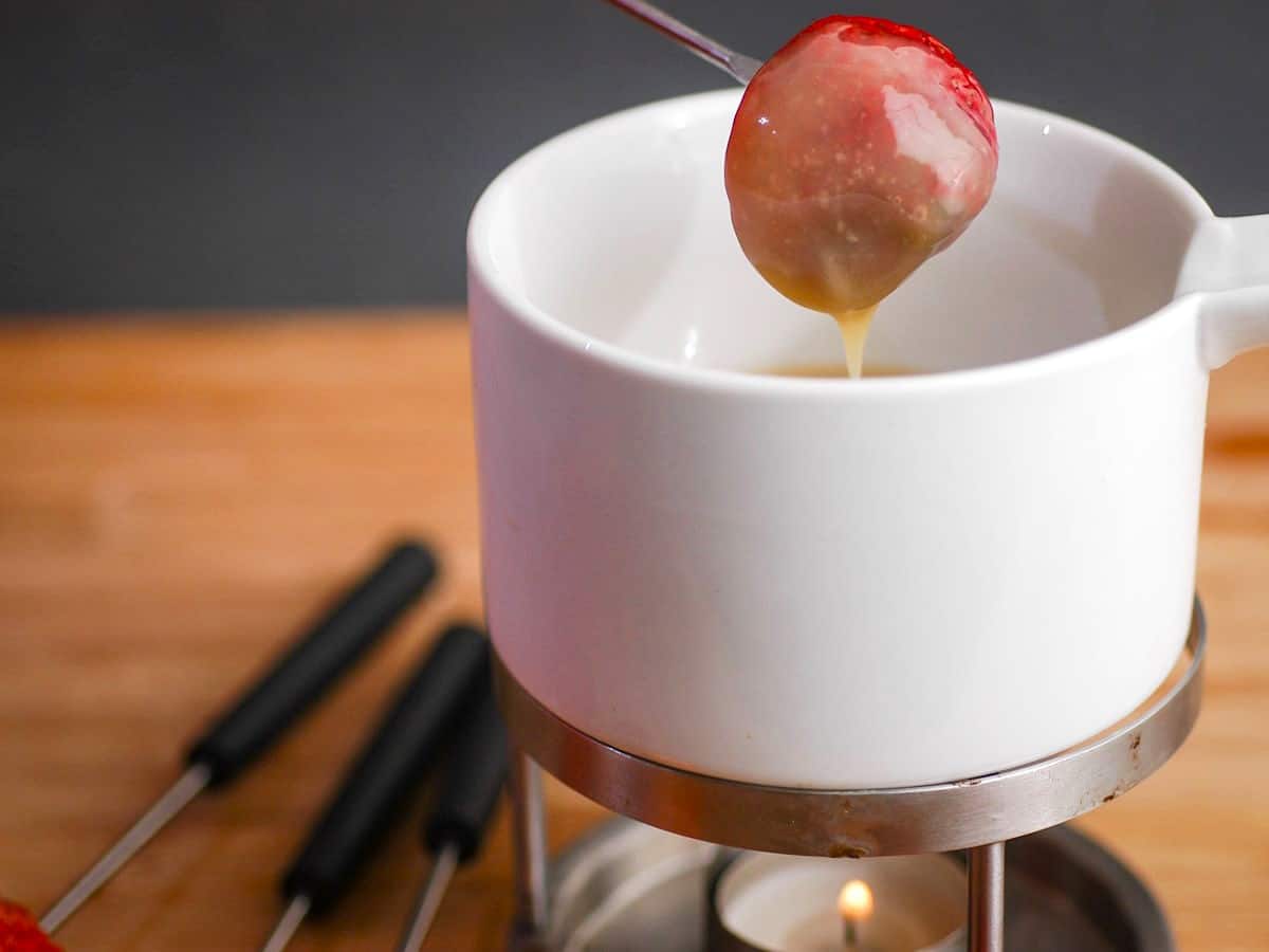 How to Make White Chocolate Ganache - Step 5 Strawberry dipped into white chocolate ganache.