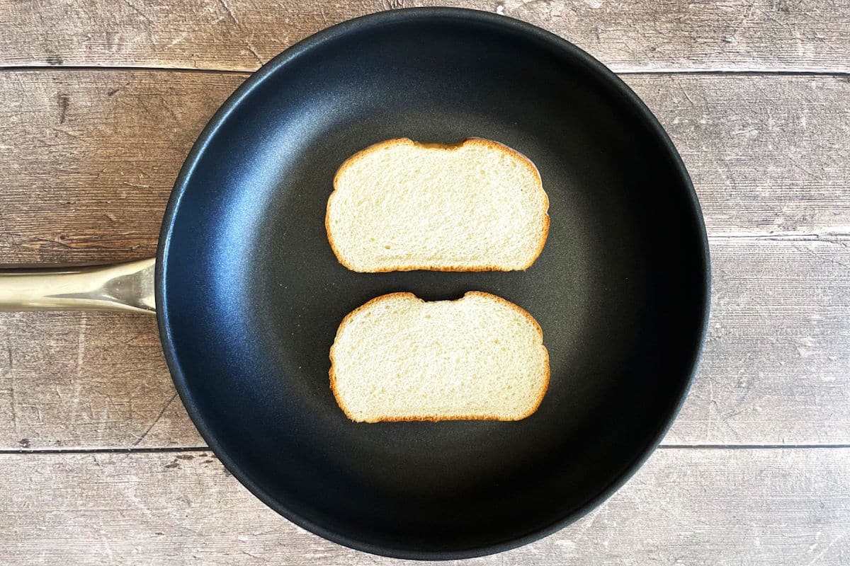 Bread slices in frying pan.