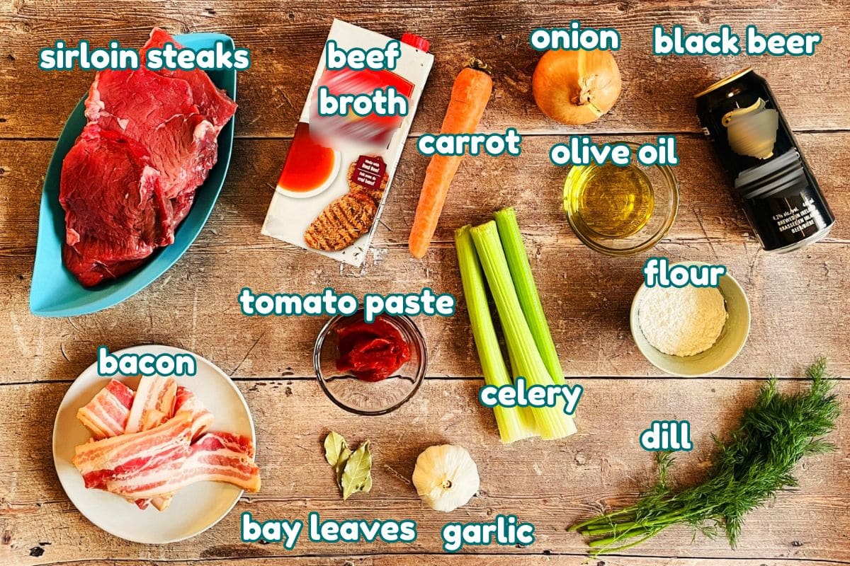 Beef Guinness stew ingredients labeled on wooden background.