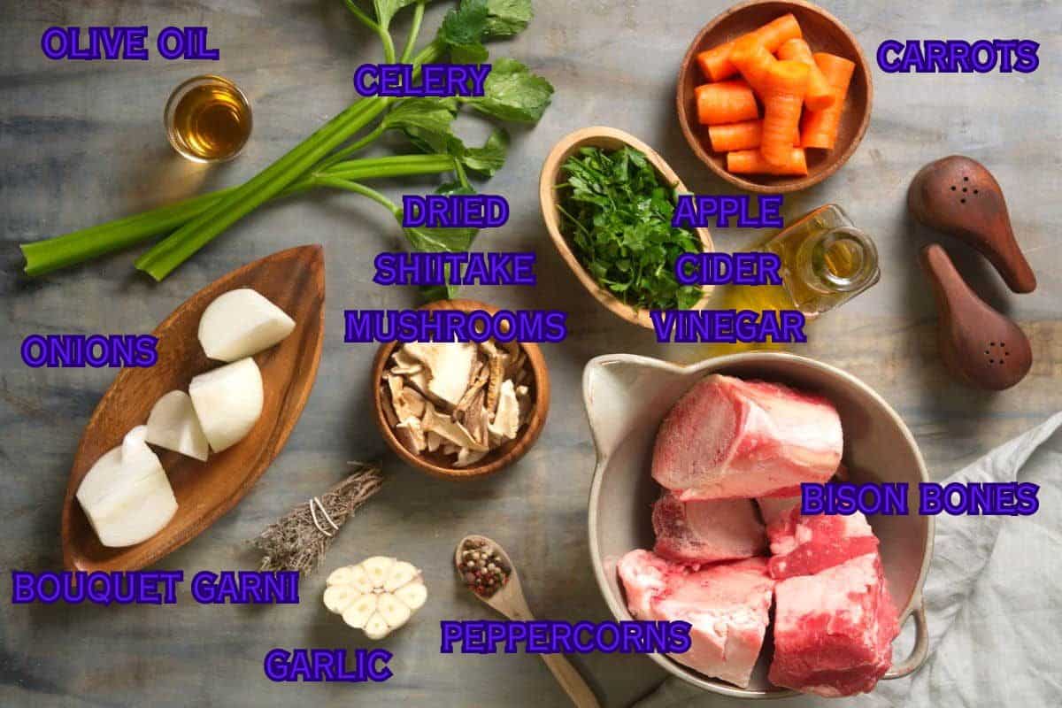 Bison bone broth ingredients prepped on grey-brown background.