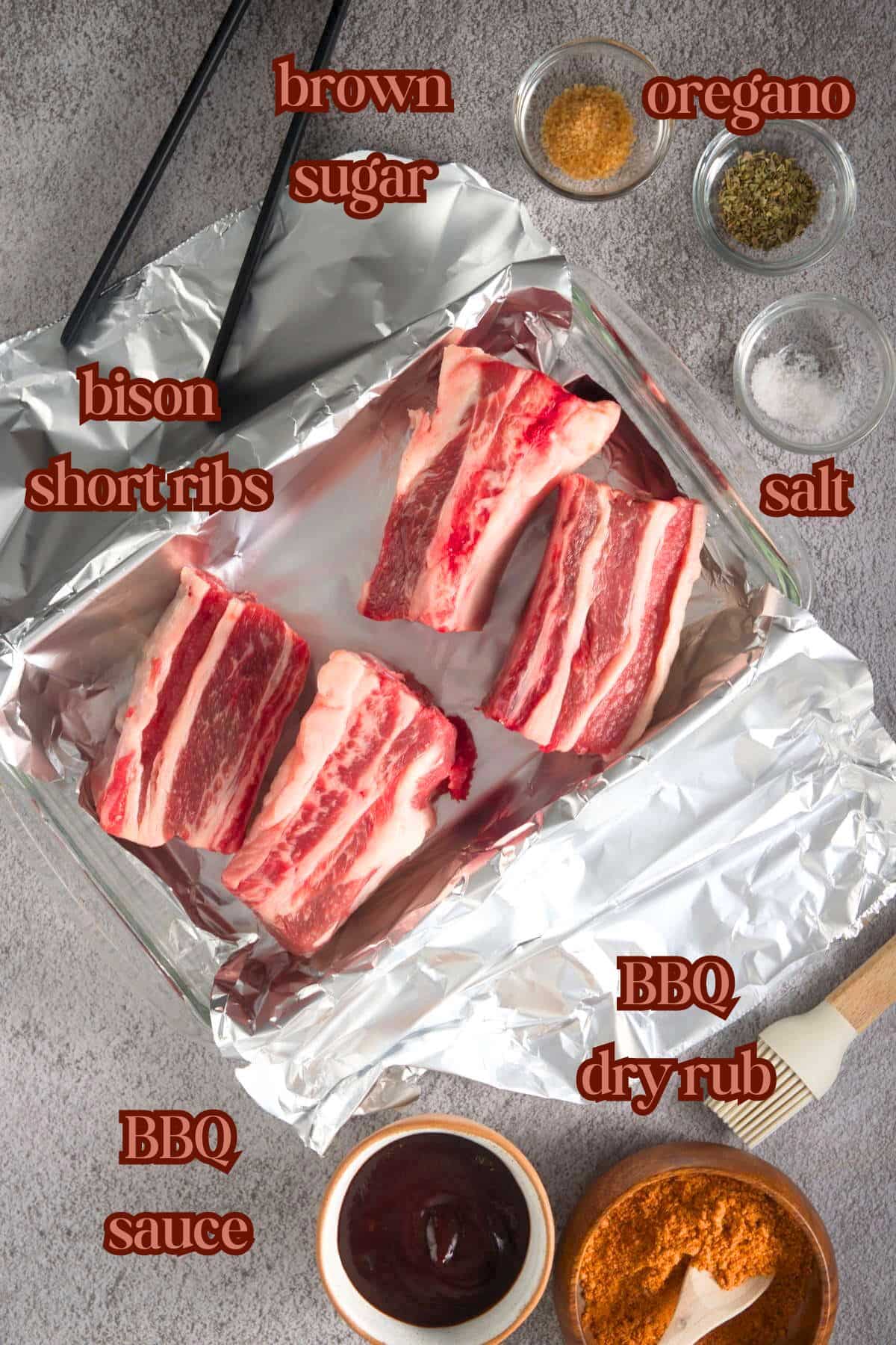 Bison BBQ ribs ingredients labeled on grey background.