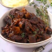 Bison stew in bowl with fresh thyme.