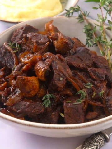 Bison stew in bowl with fresh thyme.
