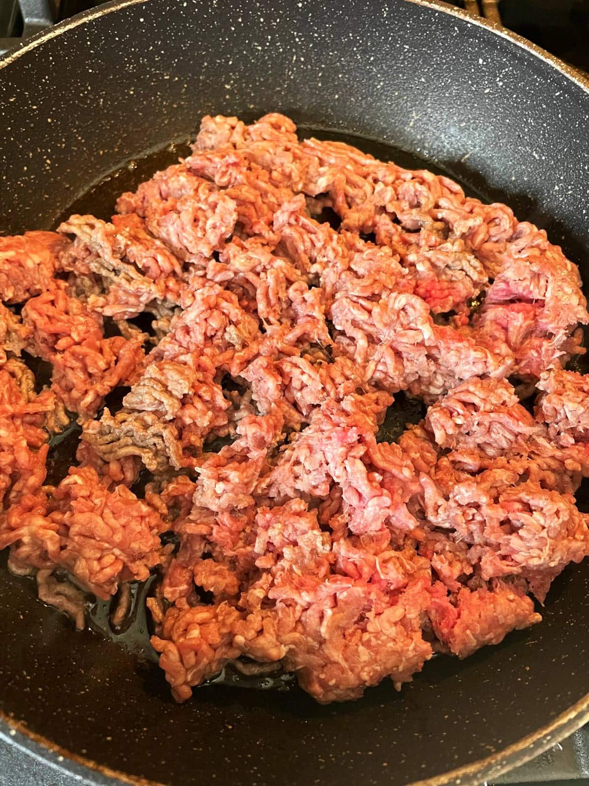 Ground bison in pan.
