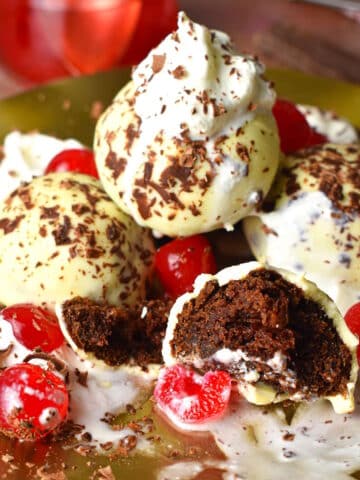 Black Forest cake balls stacked on plate.