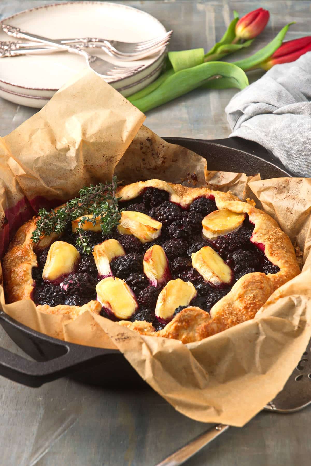 Blackberry galette with brie cheese in parchment lined pan.