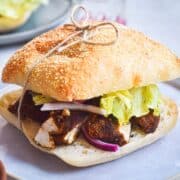 Blackened chicken sandwich tied together with twine.