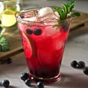 Blueberry mojito mocktail with fresh mint in cocktail glass.