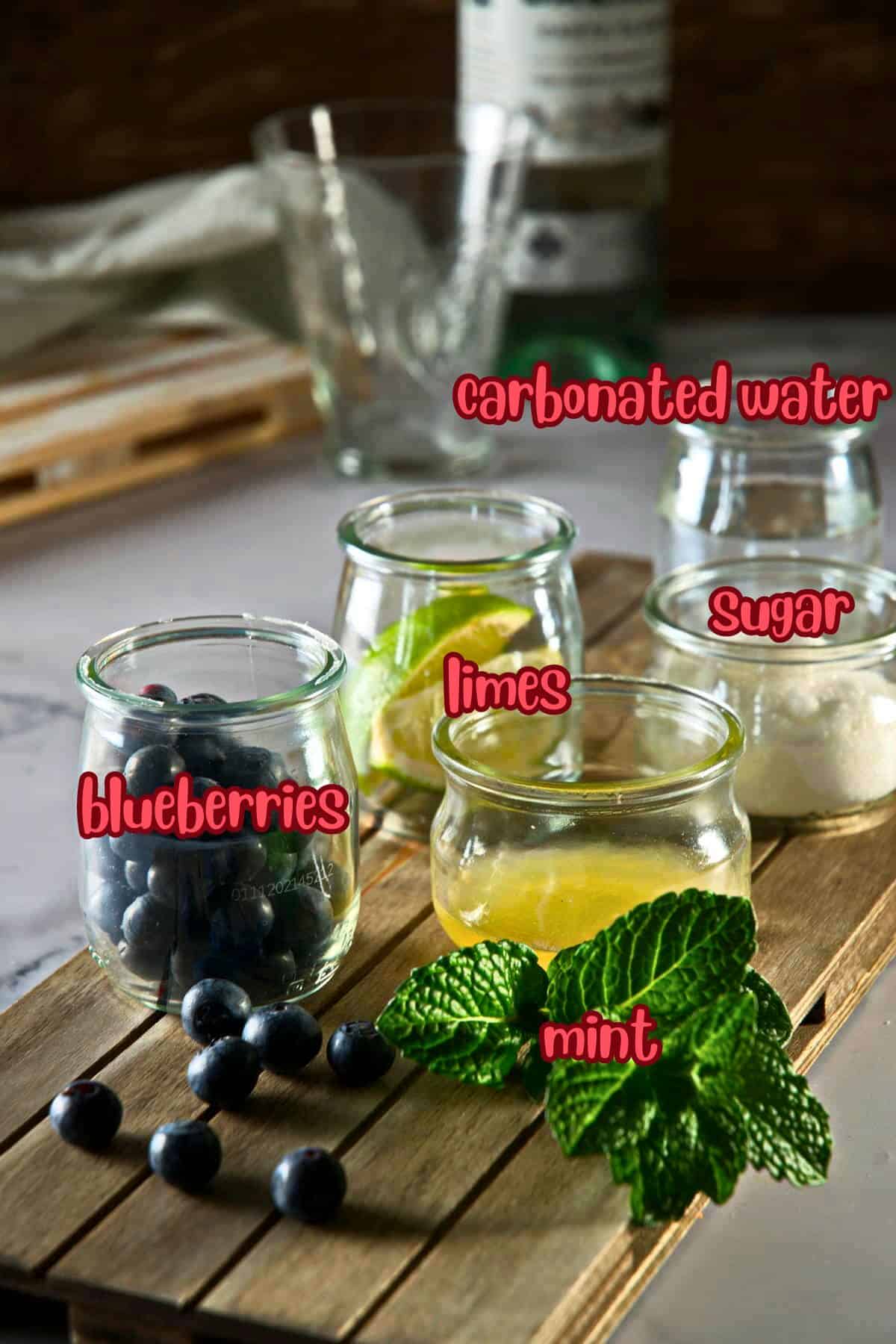 Blueberry mojito mocktail ingredients prepped and labeled.