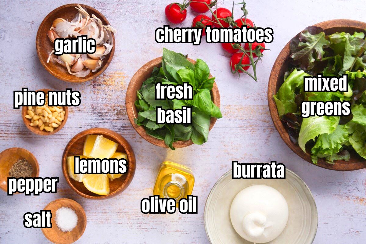Burrata salad ingredients prepped and labeled on light wooden background.
