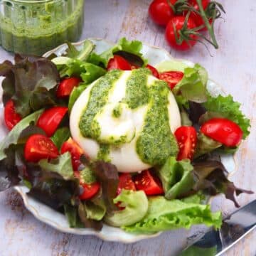 Burrata salad with pesto dressing.