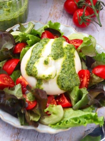 Burrata salad with pesto dressing.