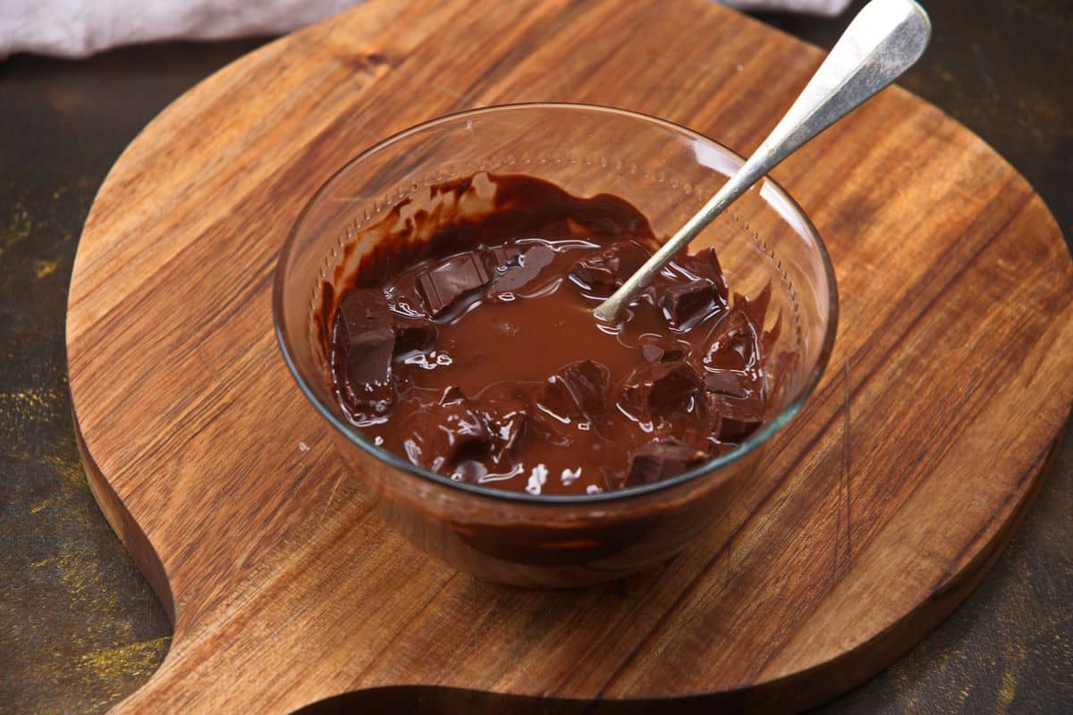 Chocolate and coconut oil mixture in small bowl melting.