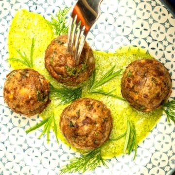 Mediterranea meatballs with fresh dill pesto on plate.