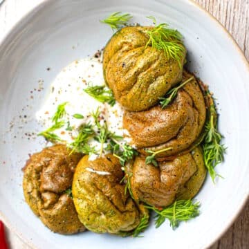 Spinach egg bites on plate with Greek yogurt.