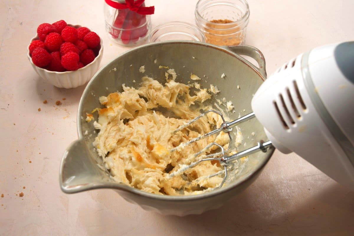 Cream cheese mixture getting whipped in bowl.