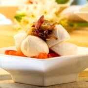 Caprese salad in small white dish.