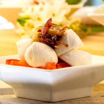Caprese salad in small white dish.