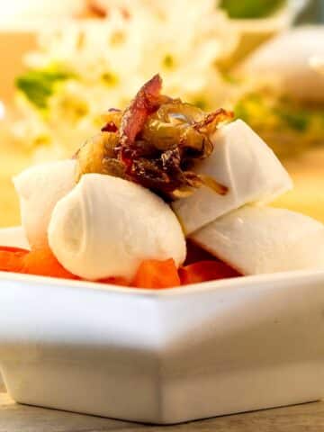 Caprese salad in small white dish.