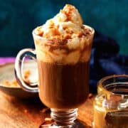 Caramel brûlée latte and sauce on blue background.