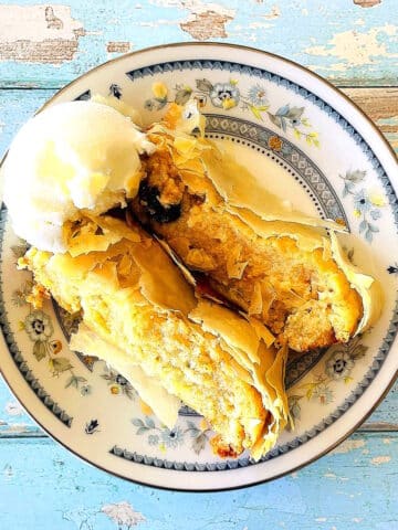 Sliced cheese strudel with a scoop of ice cream.