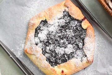 Cherry galette on sheet pan with parchment.