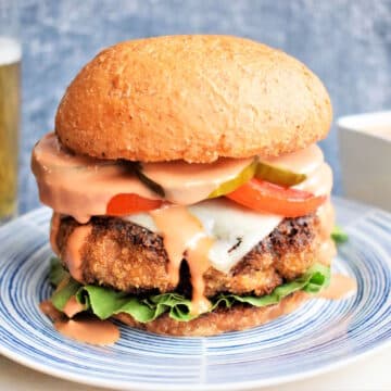 Chicken fried breaded burger on plate.
