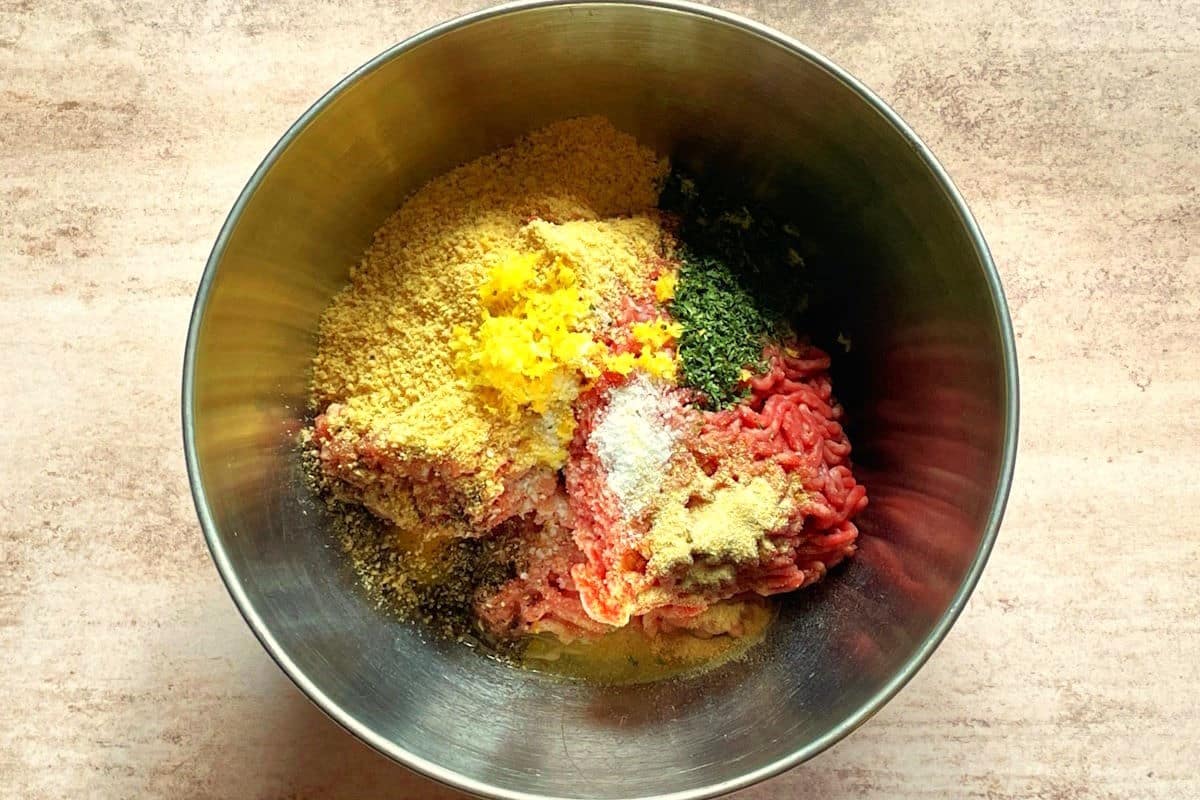 Chicken fried breaded burger ingredients in bowl.