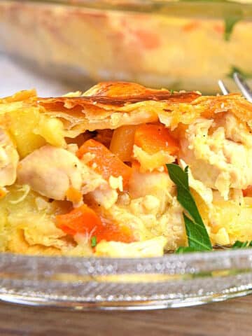 Chicken pasty pie in baking dish and on small clear glass plate.