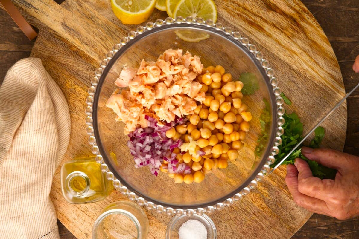 Salmon, onion and chickpeas in bowl.