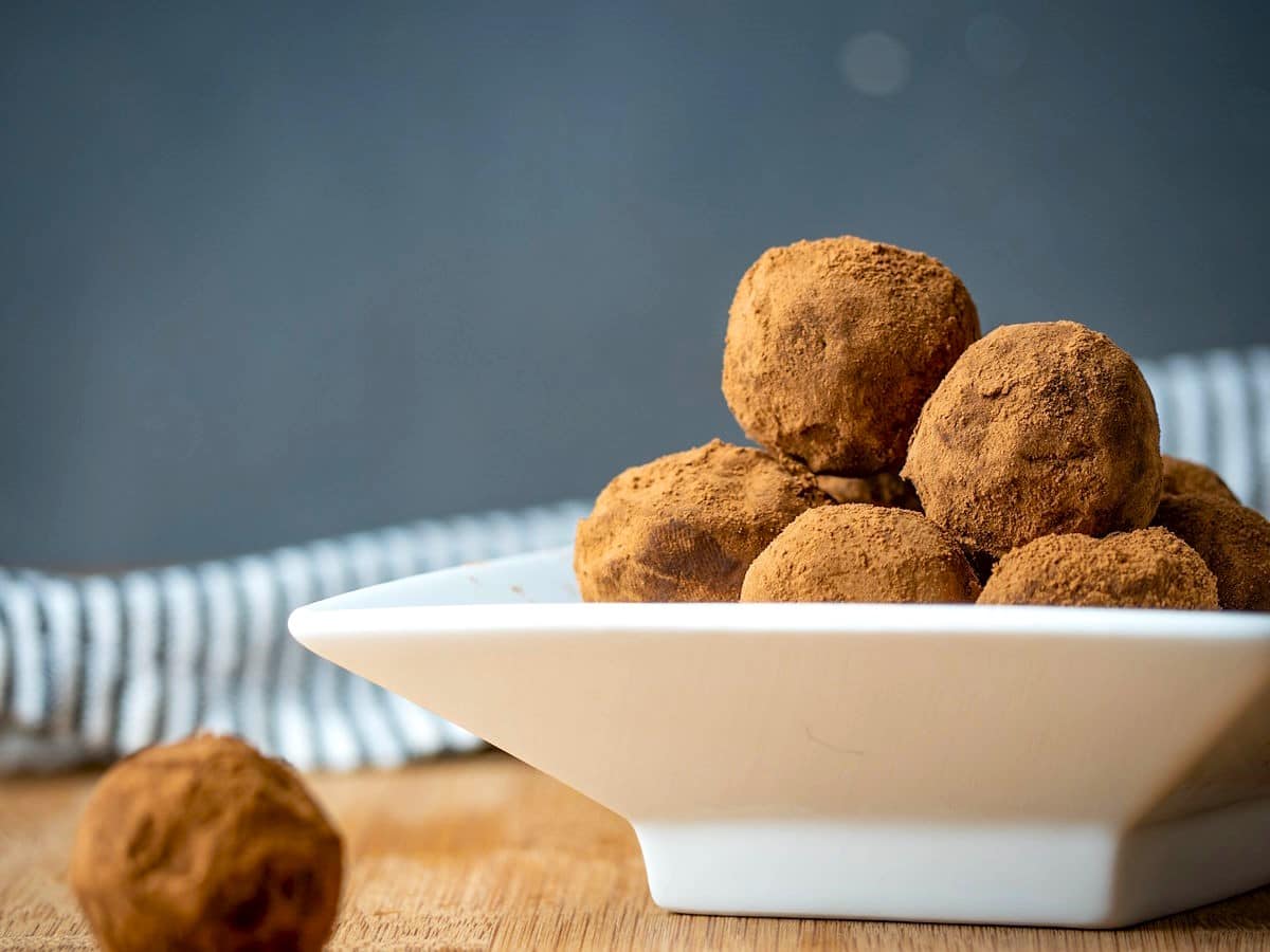 Chocolate truffles in a white dish.