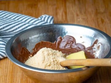 Chocolate truffle ingredients in metal bowl.