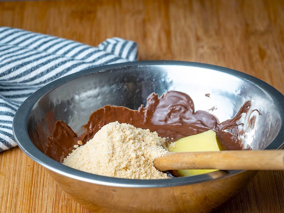 Chocolate truffle ingredients in metal bowl.