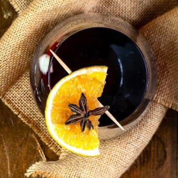 Cinnamon orange glögg in wine glass.