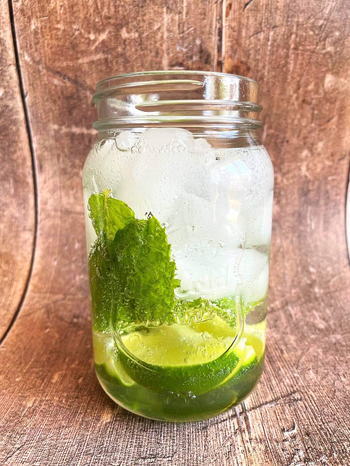 Mojito mocktail ingredients in glass.