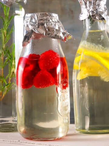 Cocktail syrups infusing in bottles.