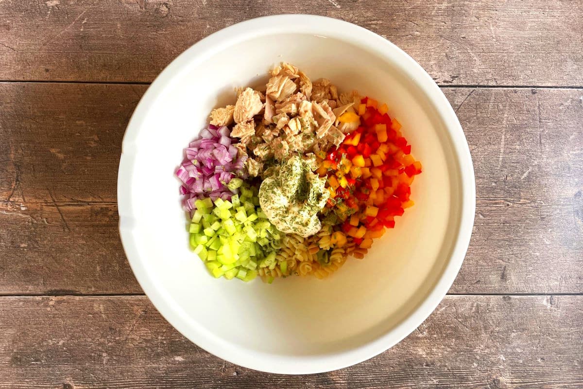 Tuna pasta salad ingredients in large bowl.