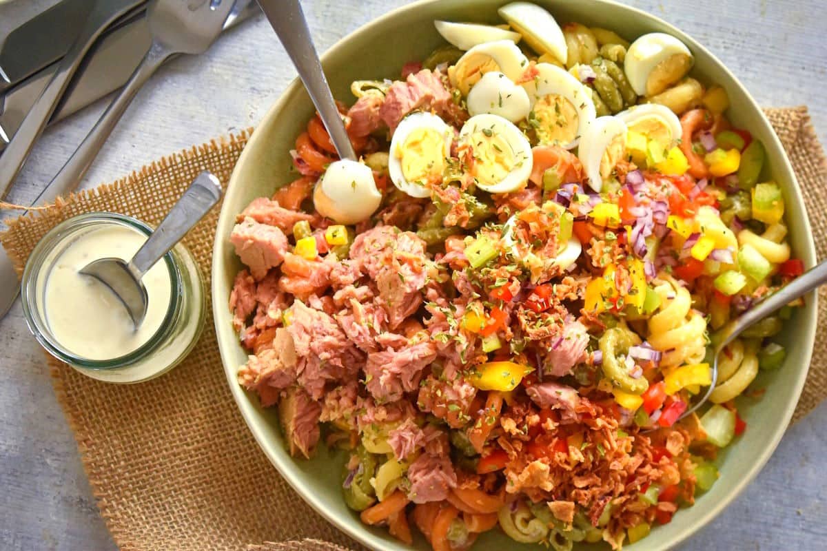 Tuna pasta salad with quail eggs in a bowl.